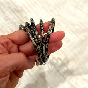 5 Snakeskin print bracelets. I think they are resin or resin coated?